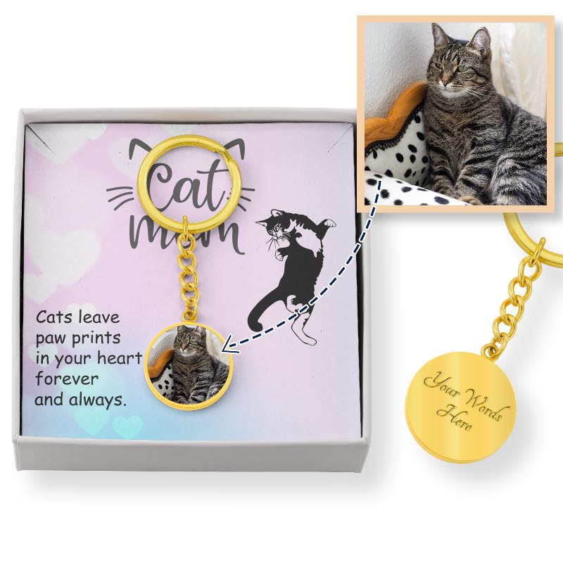 Gold keychain with cat-themed design and message, displayed with a cat photo and gift box.