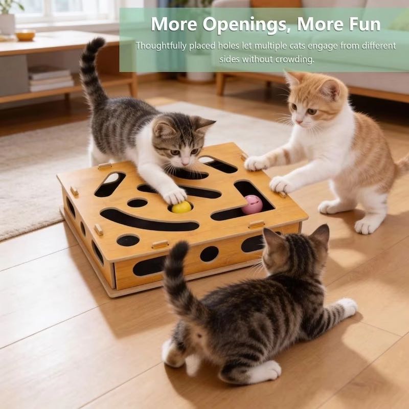 Three cats play with a wooden cat toy maze on a light wood floor in a bright room.