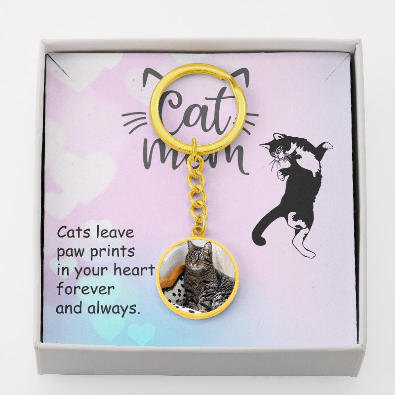 Keychain with cat charm and message card on a white background