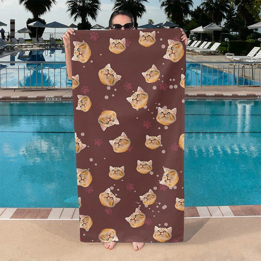 Person holding a brown cat print towel by a pool