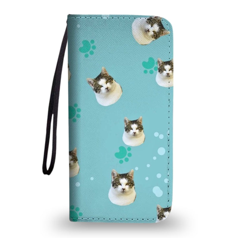 Blue clutch purse with wrist strap, featuring a custom cat face and paw print pattern, shown on a white background