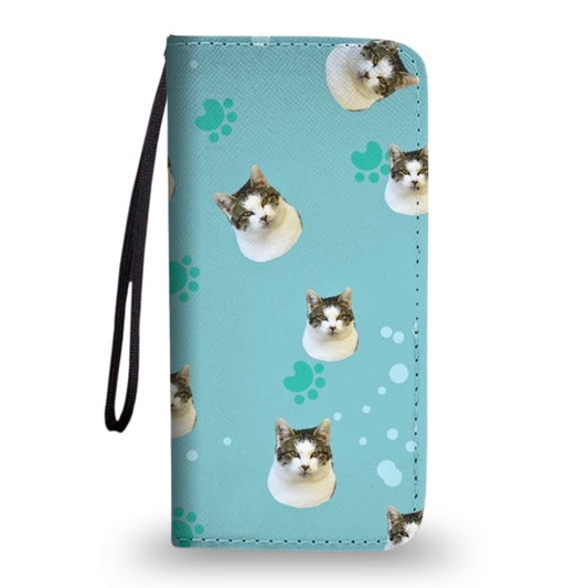 Blue clutch purse with wrist strap, featuring a custom cat face and paw print pattern, shown on a white background