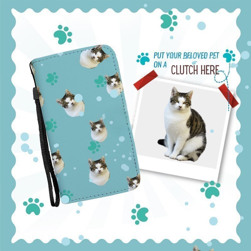 Blue clutch purse with cat pattern. Beside it is a photo of the full cat, with text indicating you can personalize the clutch using your own pet image