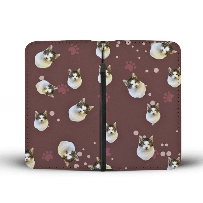 Front and back view of a brown clutch purse, with cat face and paw print pattern, displayed on a white background