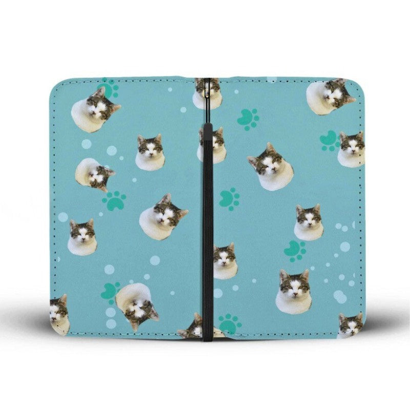 Front and back view of a clutch purse, with a cat face and paw print pattern, displayed on a white background