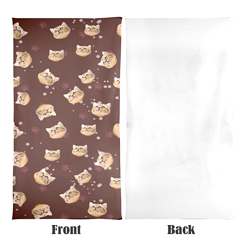 Towel with repeating cat face pattern on a brown background on the front, and a plain white back.