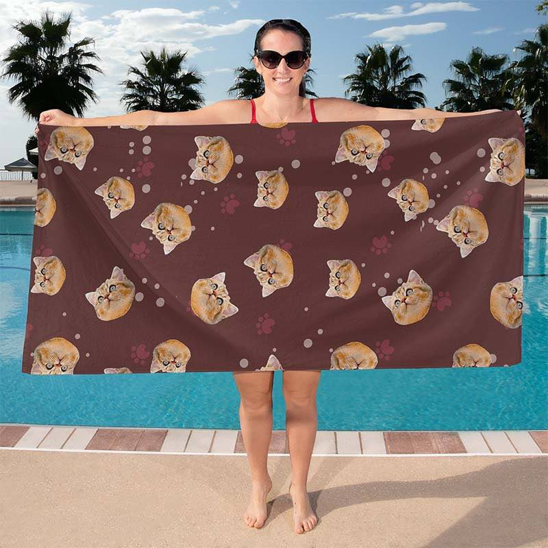 Brown cat print beach towel held by a woman by the pool
