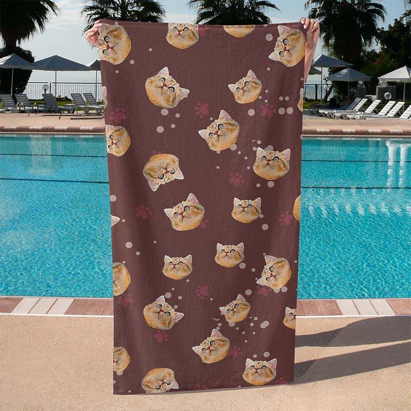 Brown cat print towel held by a person at the poolside