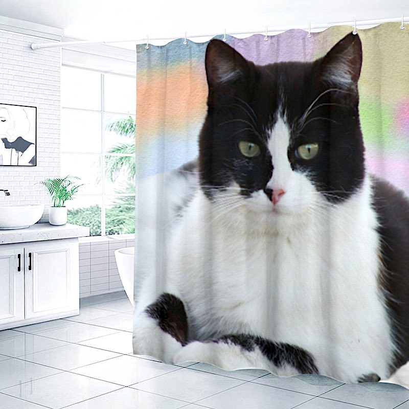 Shower curtain with a black and white cat design in a bathroom setting