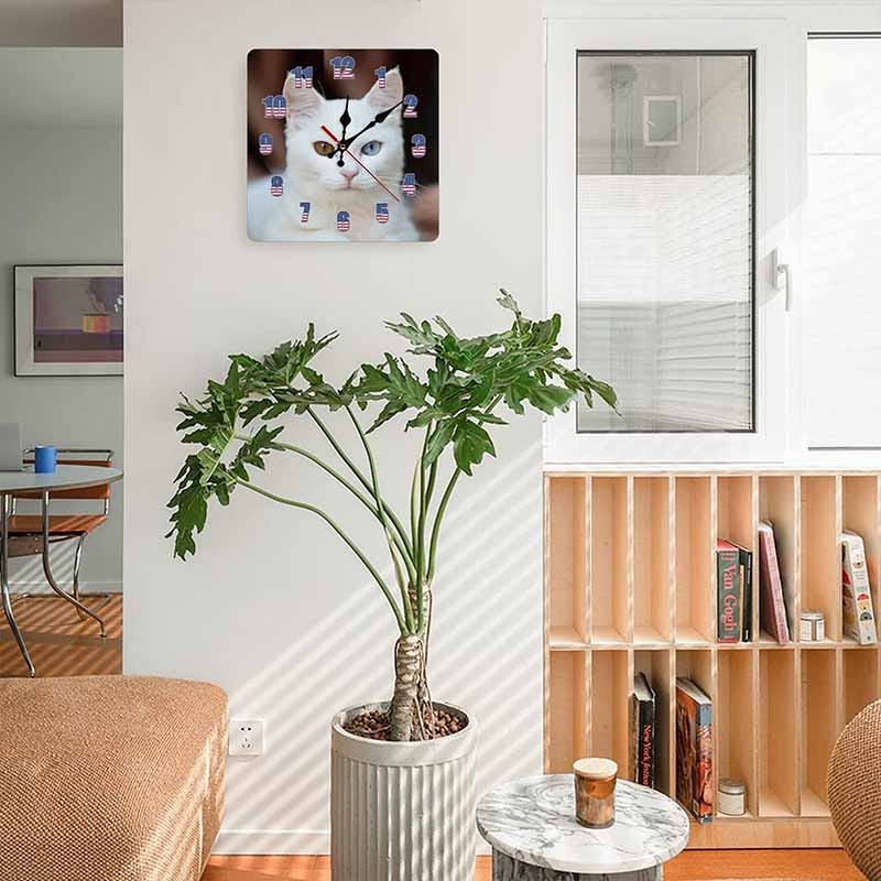 Living room featuring a cat wall clock, complemented by a plant and a bookshelf.