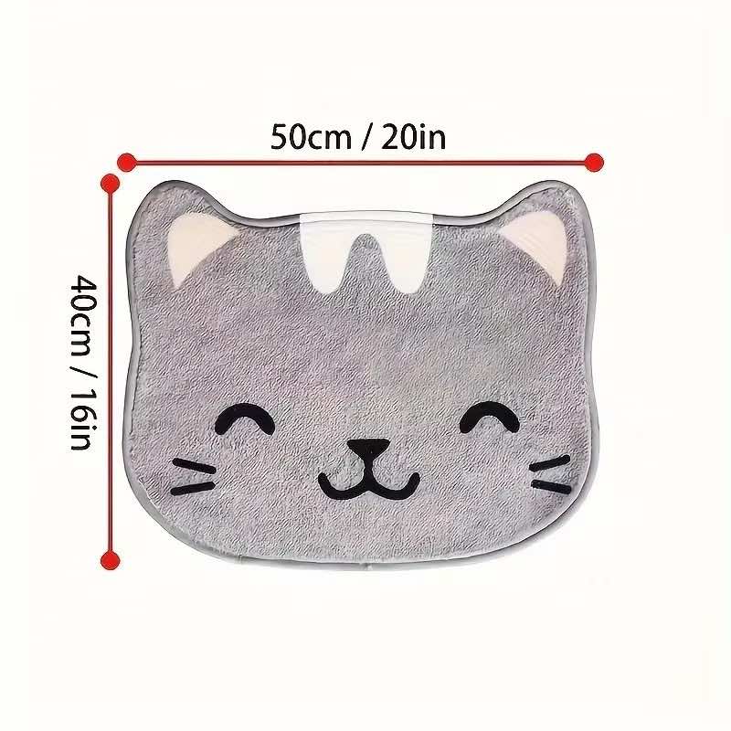A gray cat-face shaped bath mat or cushion with a smiling face and pink inner ears, shown on a white background with red dimension lines indicating 50 cm by 40 cm.